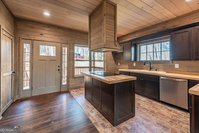 kitchen with butcher block countertops, sink, dishwasher, and a center island