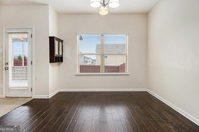 unfurnished room with dark wood-type flooring