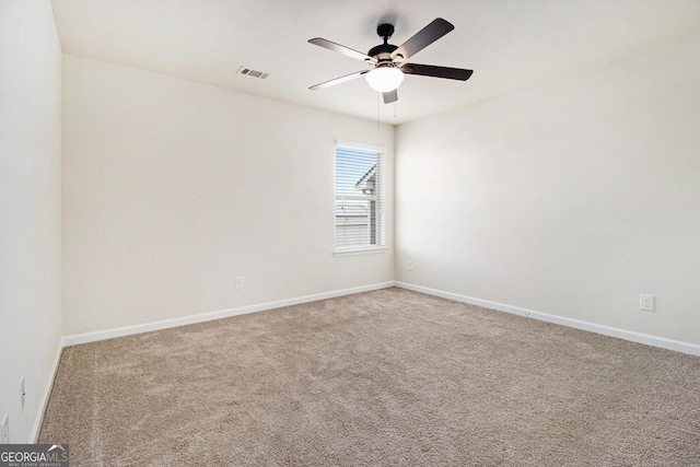 empty room featuring carpet floors and ceiling fan