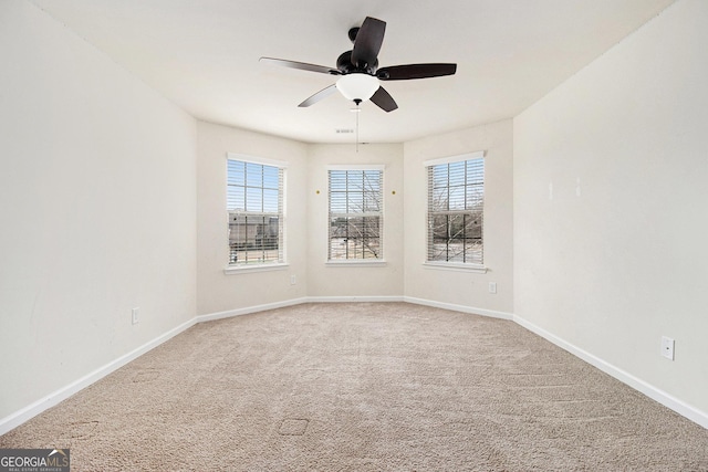 spare room featuring carpet floors and ceiling fan