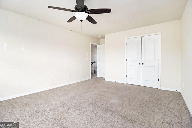 unfurnished bedroom featuring carpet floors, ceiling fan, and a closet