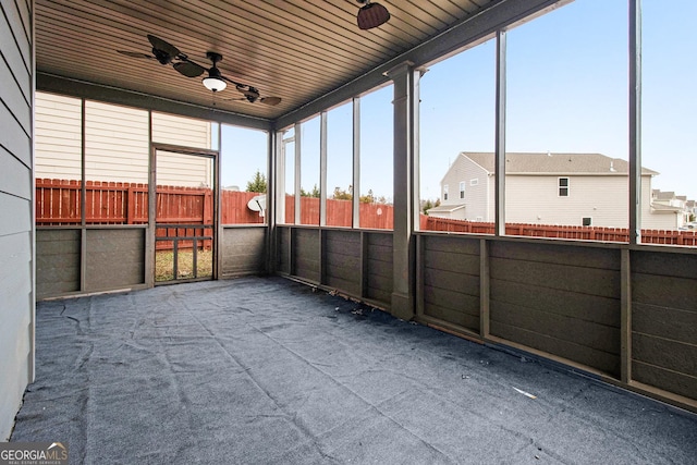 unfurnished sunroom with ceiling fan and wooden ceiling