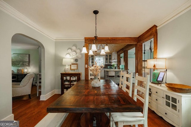 dining space featuring crown molding, dark hardwood / wood-style floors, and an inviting chandelier