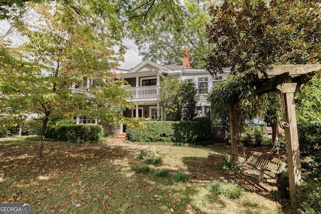 view of front of house featuring a balcony