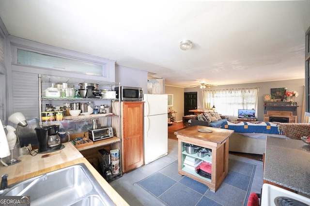 kitchen featuring ceiling fan and white refrigerator