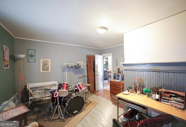 interior space with ornamental molding and light hardwood / wood-style floors