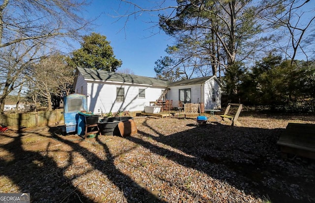 rear view of property with a wooden deck