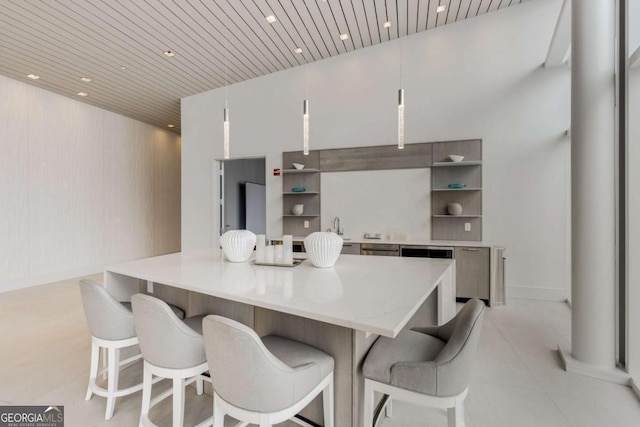 kitchen featuring open shelves, light stone counters, a kitchen breakfast bar, recessed lighting, and wooden ceiling