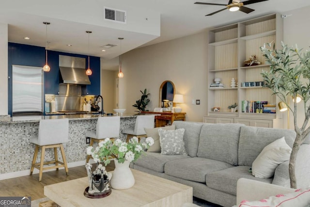 living area featuring visible vents, recessed lighting, ceiling fan, and wood finished floors