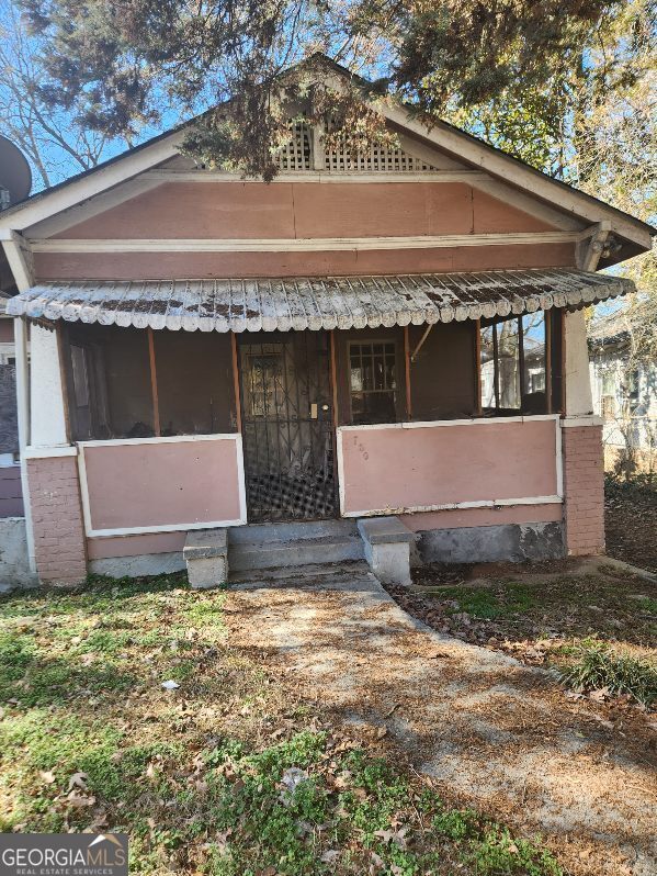 view of front of property with a sunroom