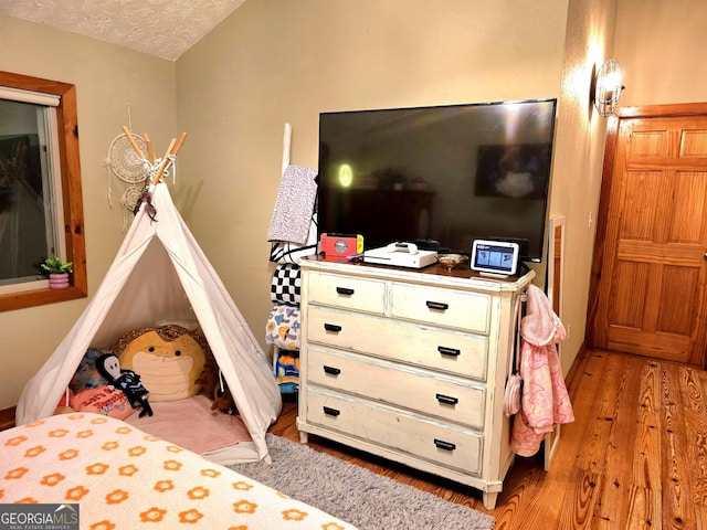 bedroom featuring a textured ceiling and light wood-type flooring