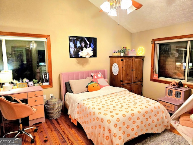 bedroom featuring ceiling fan, a textured ceiling, lofted ceiling, and wood finished floors