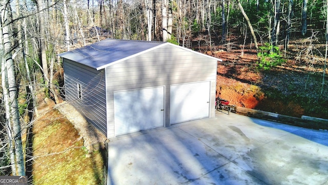 detached garage with a forest view