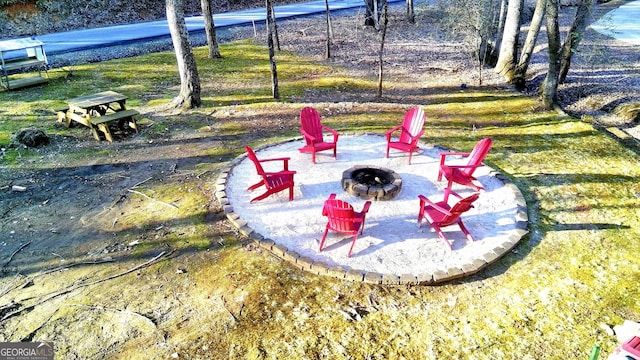 view of yard with a patio and an outdoor fire pit