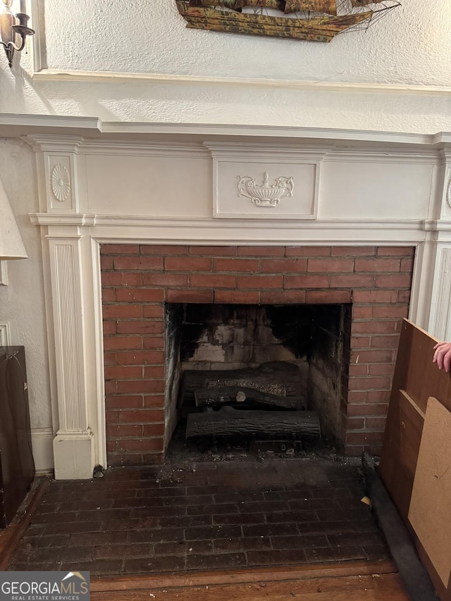 room details featuring a fireplace and wood finished floors