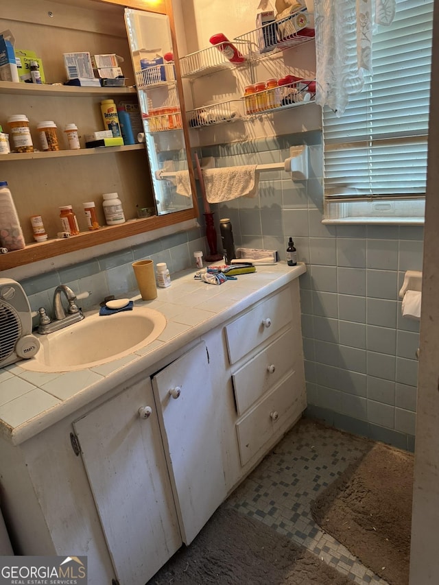 bathroom featuring vanity, tasteful backsplash, and tile walls