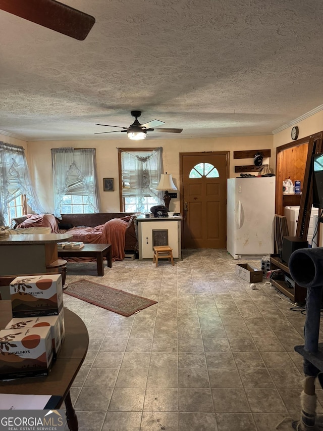tiled living room featuring ceiling fan and a textured ceiling