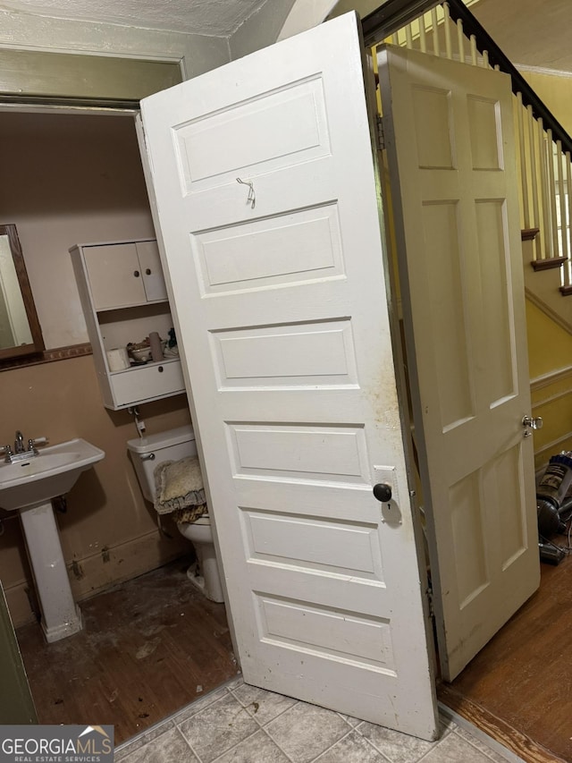 interior space with a sink and wood finished floors