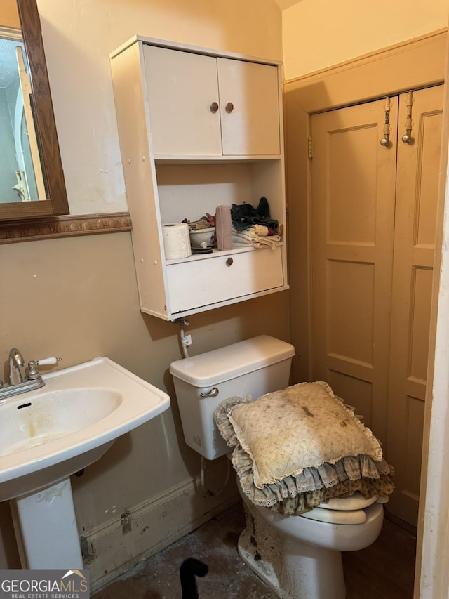 half bath featuring a sink and toilet