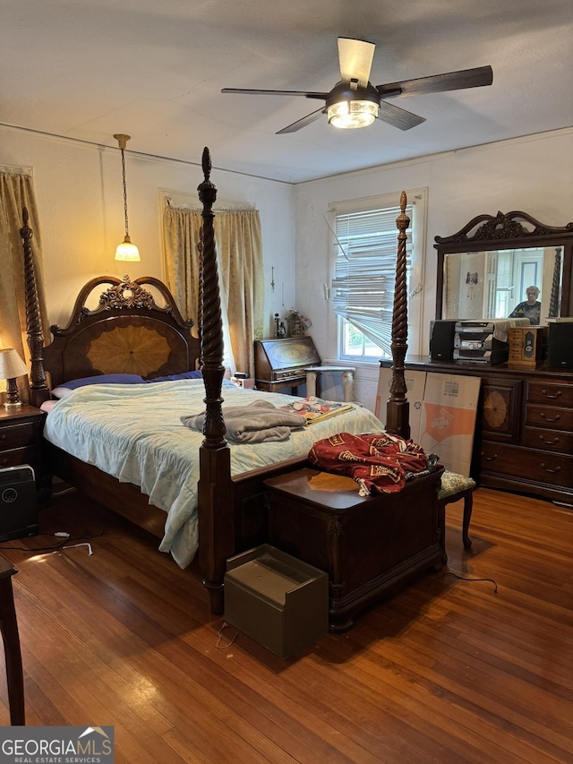 bedroom with ceiling fan and wood finished floors