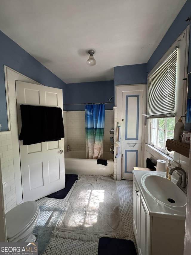 bathroom with tile patterned flooring, toilet, shower / tub combo, and vanity