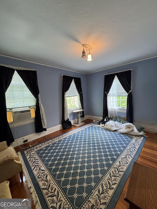 bedroom featuring crown molding, baseboards, and cooling unit
