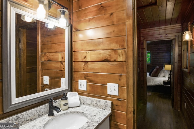 bathroom with vanity, wooden ceiling, and wood walls