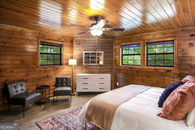 bedroom with hardwood / wood-style flooring, wood walls, and wooden ceiling