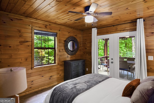 bedroom featuring french doors, multiple windows, and access to outside