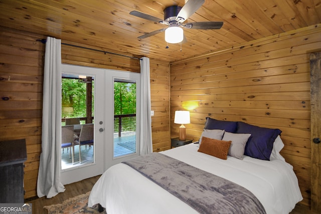 bedroom with dark hardwood / wood-style floors, wood walls, access to outside, wood ceiling, and french doors