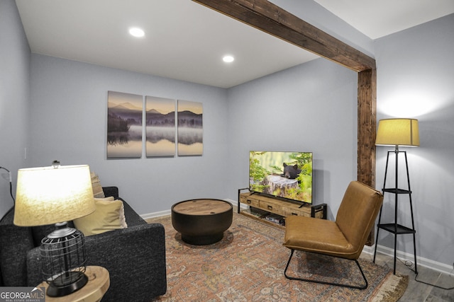 sitting room featuring beamed ceiling