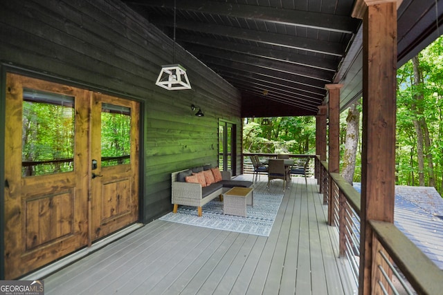 wooden deck with french doors and an outdoor living space