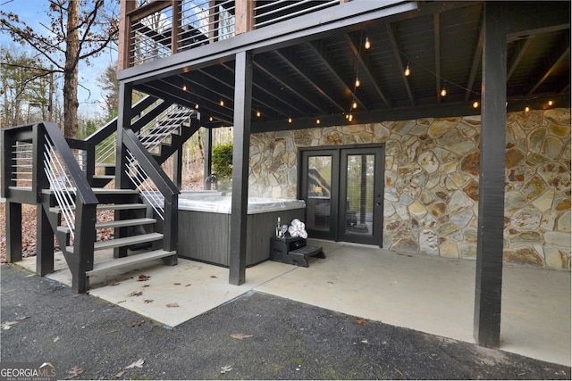 view of patio / terrace featuring a hot tub and french doors