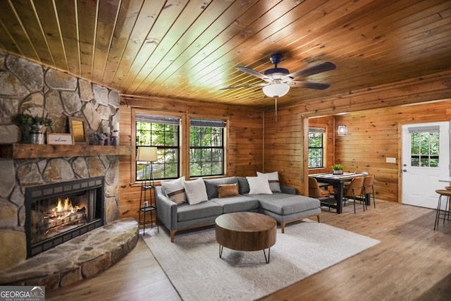 living room featuring plenty of natural light, a fireplace, hardwood / wood-style floors, and wooden ceiling