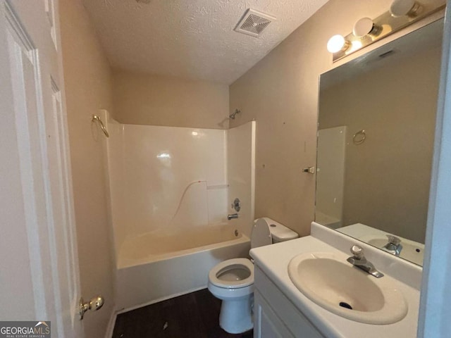 40 Brandon Dr, Covington, GA 30016 - full bathroom featuring vanity, toilet, tub / shower combination, and a textured ceiling