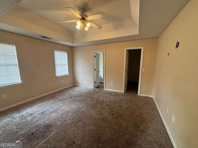 40 Brandon Dr, Covington, GA 30016 - empty room with a raised ceiling, carpet floors, and ceiling fan