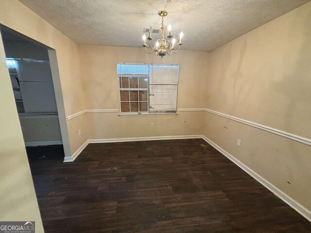 40 Brandon Dr, Covington, GA 30016 - unfurnished dining area with dark wood-type flooring, a chandelier, and a textured ceiling