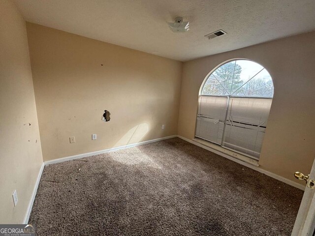 40 Brandon Dr, Covington, GA 30016 - spare room with a textured ceiling and carpet flooring