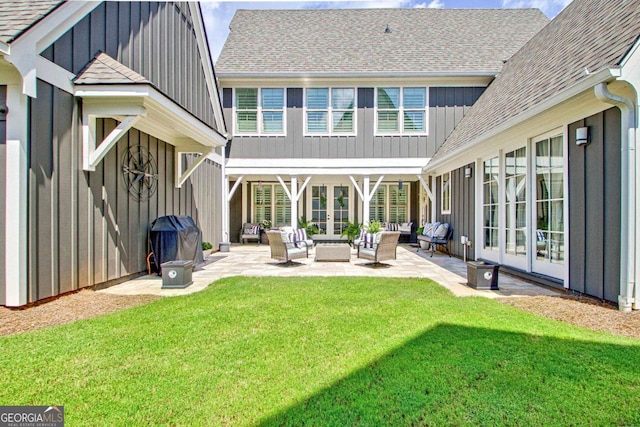 rear view of house featuring a yard, a patio area, outdoor lounge area, and french doors