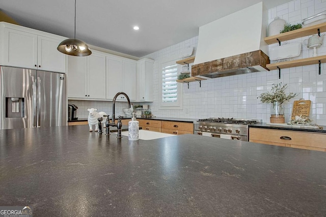 kitchen featuring pendant lighting, white cabinetry, sink, custom exhaust hood, and stainless steel appliances