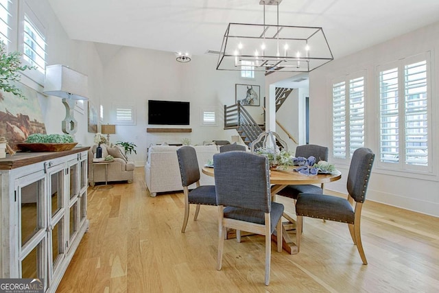 dining space with an inviting chandelier and light wood-type flooring