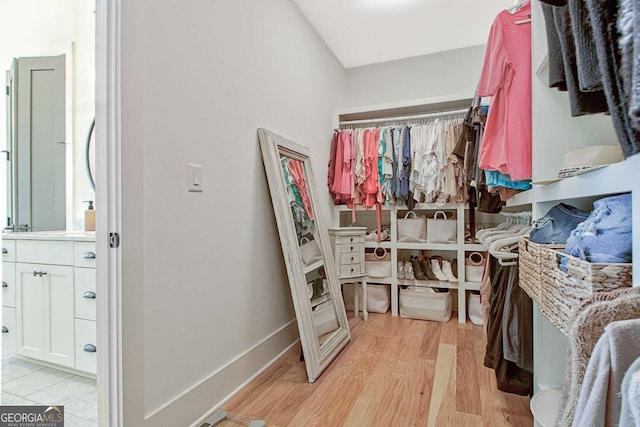 spacious closet with light hardwood / wood-style flooring