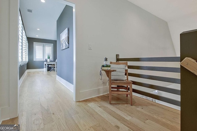 corridor with light hardwood / wood-style flooring