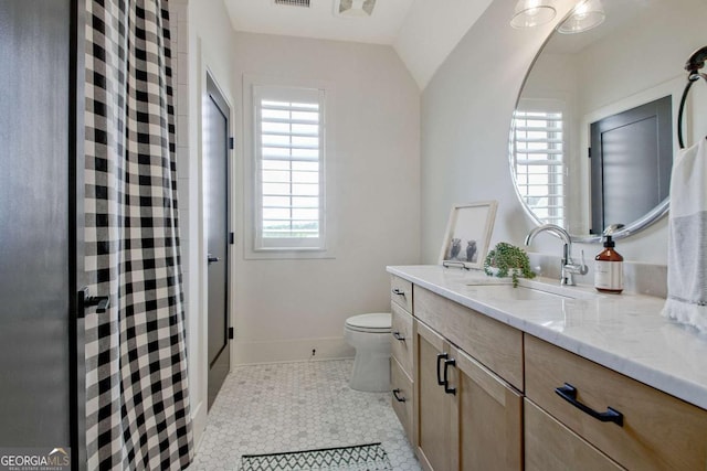 bathroom with vanity, tile patterned floors, and toilet