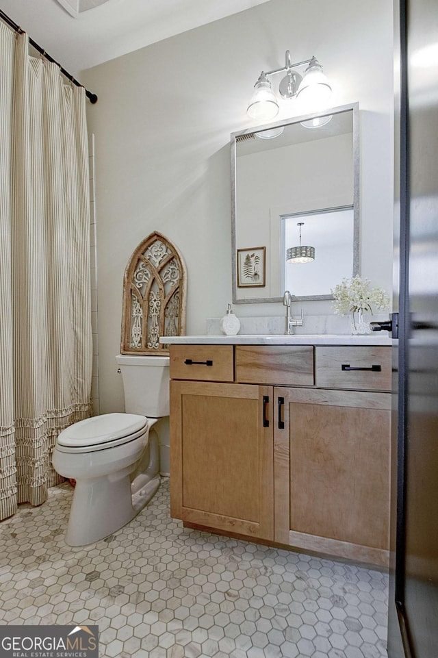 bathroom with vanity, walk in shower, and toilet