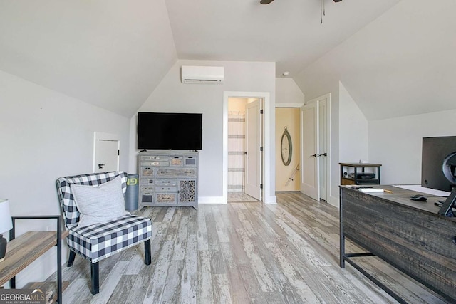 living area featuring vaulted ceiling, an AC wall unit, ceiling fan, and light hardwood / wood-style flooring