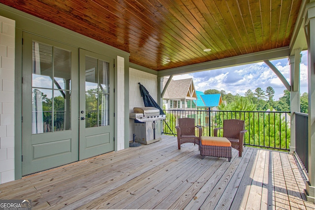 wooden deck featuring a grill and french doors