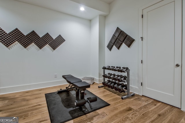 exercise room with hardwood / wood-style floors