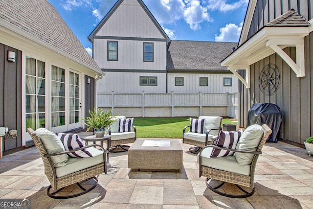 view of patio featuring a grill and an outdoor living space with a fire pit