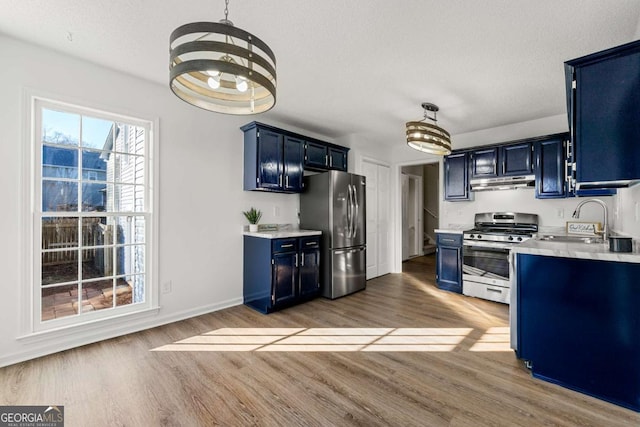 kitchen with sink, stainless steel appliances, and blue cabinets